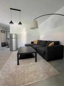 a living room with a couch and a table at Apartmán Proseč-Obořiště in Nová Cerekev