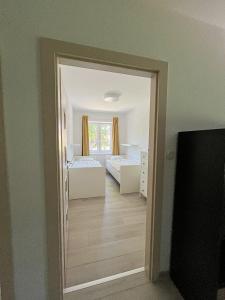 a view of a bedroom with two beds and a mirror at Apartmán Proseč-Obořiště in Nová Cerekev