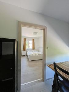 a bedroom with a bed and a room with a table at Apartmán Proseč-Obořiště in Nová Cerekev +32 photos