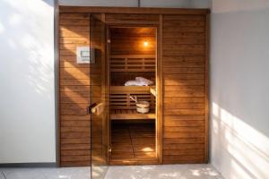 a walk in closet with a wooden wall at Villas Verde Dalmatia in Jesenice