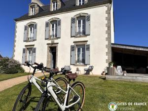 a bike parked in front of a house at La Belle Epoque in Kerlaz