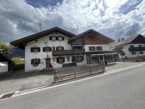 a large white building on the side of a street at Ferienwohnung 2 Am Krepbach in Grainau