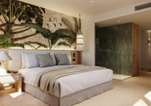 a bedroom with a large bed with a painting on the wall at HD Sensarena - Adults Only in Costa Teguise