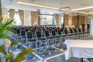 a conference room with rows of chairs and a table at Hotel Rubin DHS in Kruševac +34 photos