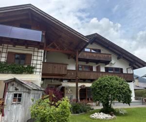 a house with a solar panel on top of it at Ferienwohnung 1 Am Krepbach in Grainau