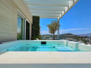 a swimming pool in the middle of a house at One 360 Skyline Athens Penthouses in Athens