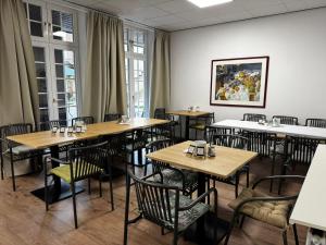 a dining room with wooden tables and chairs at Hotel Borchers in Celle