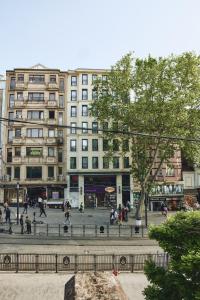 a group of people walking in a city with a building at igman Hotel İstanbul in Istanbul