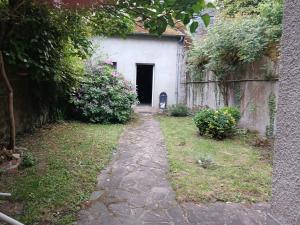 a path leading to a building with a door at Maison familiale en centre bourg in Ahun