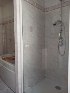 a bathroom with a shower and a tub and a shower at Maison familiale en centre bourg in Ahun