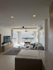 a living room with a couch and a table at Villa Tara - Sea view 5Br Rawai in Ban Saiyuan (1)