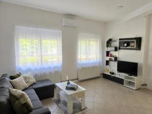 a living room with a couch and a table at Iskra Apartment 2 in Kragujevac
