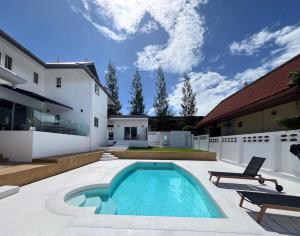 a swimming pool in the backyard of a house at Villa Tara - Sea view 5Br Rawai in Ban Saiyuan (1)
