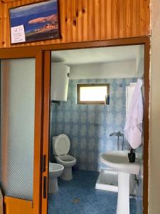 a bathroom with a toilet and a sink at Blero Rooms Rent in Pogradec +29 photos