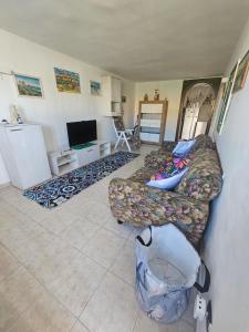 a living room with a couch and a tv at Villetta maddalena in Lecce