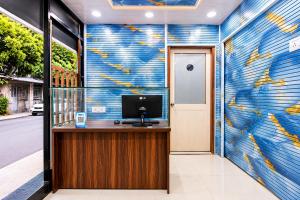 an office with a blue and yellow mural on the wall at Hotel Platinum in Mumbai