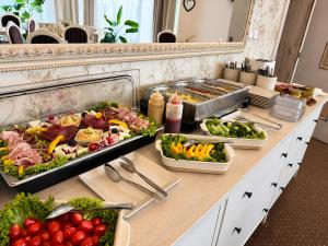a buffet with many different types of food on a table at Penzión Lapáš u Hoffera in Nitra
