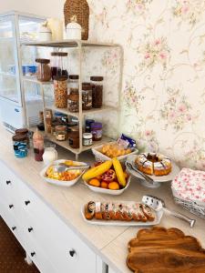 a counter with many plates of food on it at Penzión Lapáš u Hoffera in Nitra