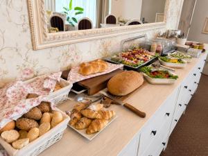 a buffet with many different types of bread and vegetables at Penzión Lapáš u Hoffera in Nitra +9 photos