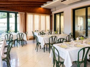 a dining room with tables and chairs with white tablecloths at Hotel Ristorante Selene in Alba Adriatica