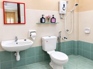 a bathroom with a toilet and a sink at Family Retreat w Kid Pool, BBQ Games Sleeps 10pax Melaka in Kampong Beringin +50 photos