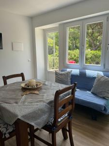 a dining room with a table and a couch at Villa Rosmarino sea view in Capraia +13 photos