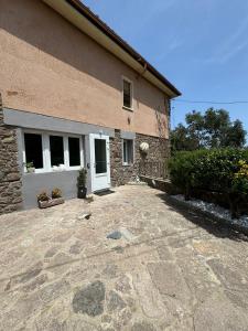 a house with a stone driveway in front of it at Villa Rosmarino sea view in Capraia