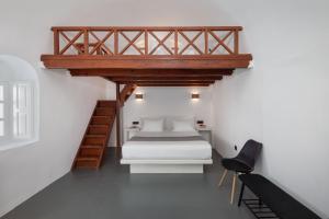 a small bedroom with a bed and a loft at Elios Cave Suites in Oia +54 photos