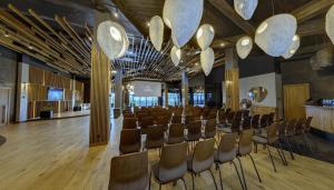 a conference room with chairs and a bar at Apartel Skhidnytsya in Skhidnitsa +122 photos