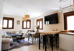 a kitchen and living room with a table and chairs at Casa Santiago in Panticosa
