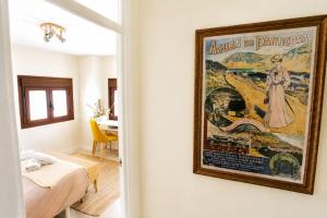 a painting hanging on a wall in a room at Casa Santiago in Panticosa