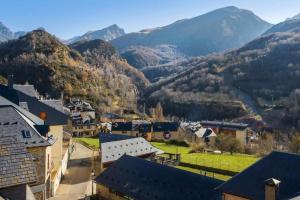 a small town in the mountains with houses and buildings at Casa Santiago in Panticosa
