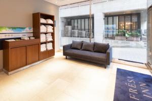 a waiting room with a couch in a store at Sotetsu Fresa Inn Tokyo-Akasaka in Tokyo
