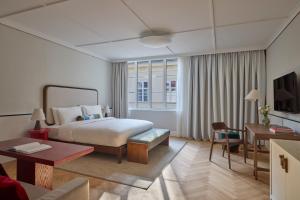 a hotel room with a bed and a desk at Miiro Spittelberg NEW OPENING in Vienna