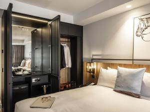 a hotel room with a bed with a mirror at Mercure Sydney Rouse Hill in Kellyville +37 photos
