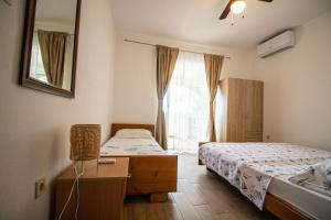 a bedroom with two beds and a window at Apartments Petar Maksan in Pakoštane