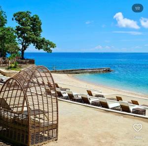 a group of chairs in a cage on a beach at Ocean View Escape at The Mactan Newtown in Punta Engaño