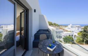a balcony with a table and a view of the ocean at Anemone Luxury Suites in Fira +72 photos