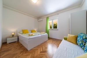 a small bedroom with a bed and a window at Rooms and Apartments Lidija in Lopar