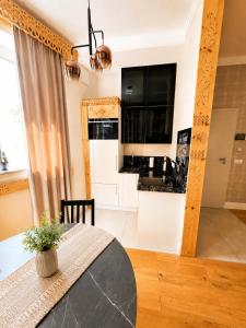 a kitchen and dining room with a table and a counter at My Mountain View - 50 m od Krupówek in Zakopane