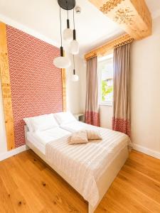 a bedroom with a large white bed in front of a window at My Mountain View - 50 m od Krupówek in Zakopane