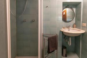 a bathroom with a sink and a shower at Rio Marina central apartment- 200m dal mare in Rio Marina +21 photos