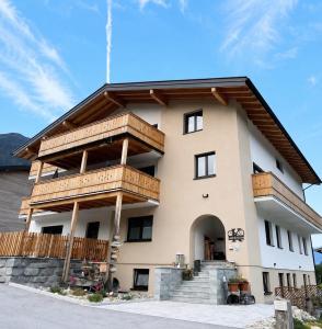 a large building with wooden balconies on it at Boutique Appartements Kumming inkl Nationalparkcard in Rauris +86 photos
