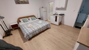 a bedroom with a bed with two pillows on it at Komforna Soba U Centru #3 in Mladenovac