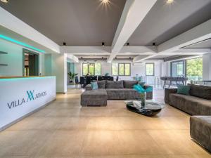 a large living room with couches and a table at Villa Athos in Corfu +67 photos