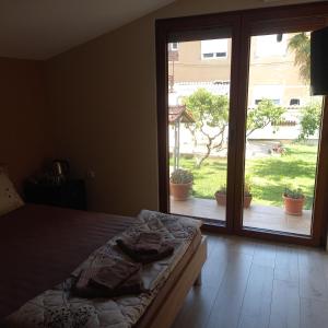 a bedroom with a bed and a sliding glass door at Sofija apartments in Gevgelija