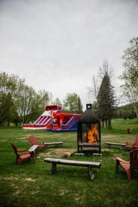 a fire pit in a park with a playground at Hotel Lac Carling Spa Golf in Harrington