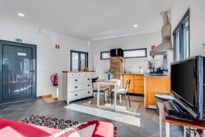 a living room with a table and a kitchen at Studio - Old Town Albufeira in Albufeira