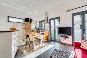 a kitchen and dining room with a table and a tv at Studio - Old Town Albufeira in Albufeira +17 photos