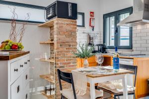 a kitchen with a table with wine glasses on it at Studio - Old Town Albufeira in Albufeira